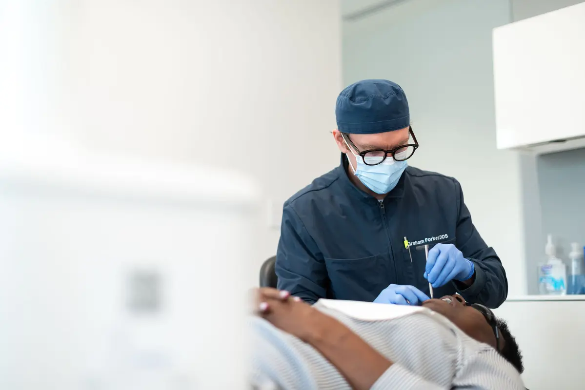 Dr. Forbes examining patient